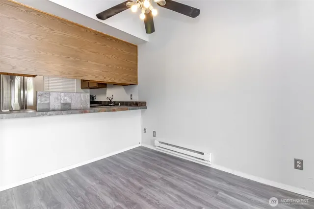 a view of a kitchen with a sink and a refrigerator