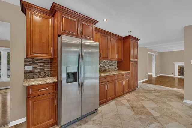 a kitchen with stainless steel appliances granite countertop a refrigerator and a sink