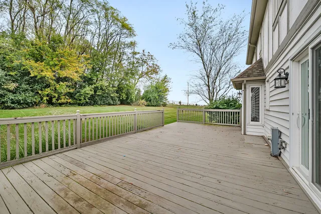 a view of a house with a big yard and potted plants