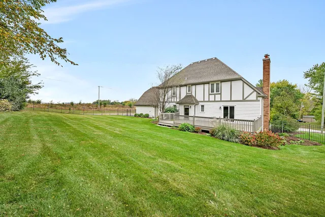 a view of a house with a yard and potted plants