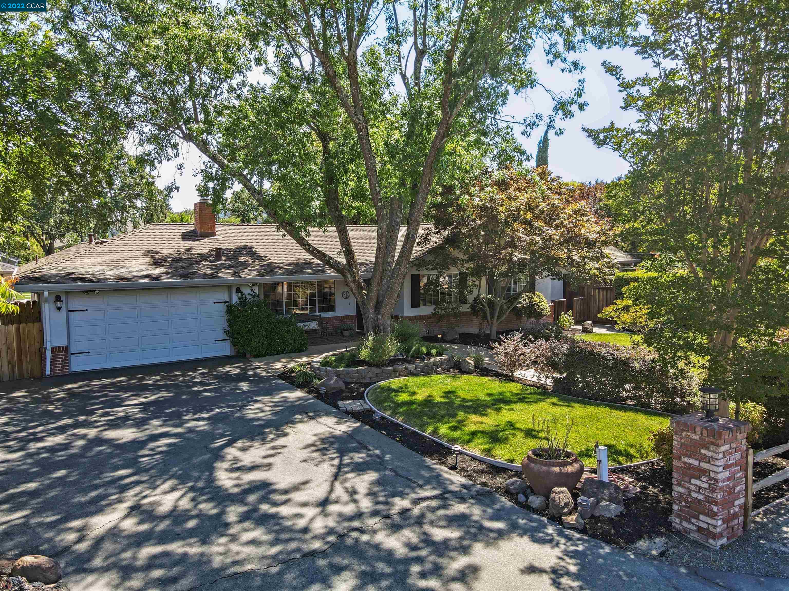 a view of a backyard with large trees