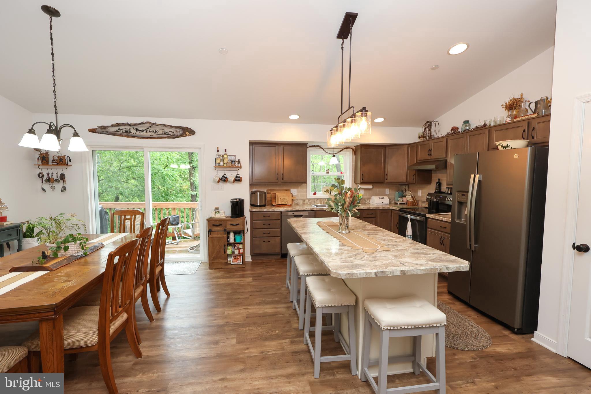 16919 Shaffer Road Sharpsburg, MD 21782 - Photo 6 of 58 a dining room with stainless steel appliances granite countertop a table chairs and a refrigerator