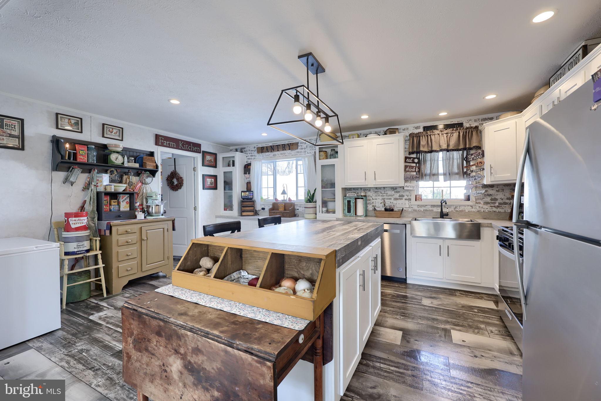 1395 Bowmansville Road Mohnton, PA 19540 - Photo 16 of 26 a open kitchen with stainless steel appliances granite countertop a refrigerator and a stove