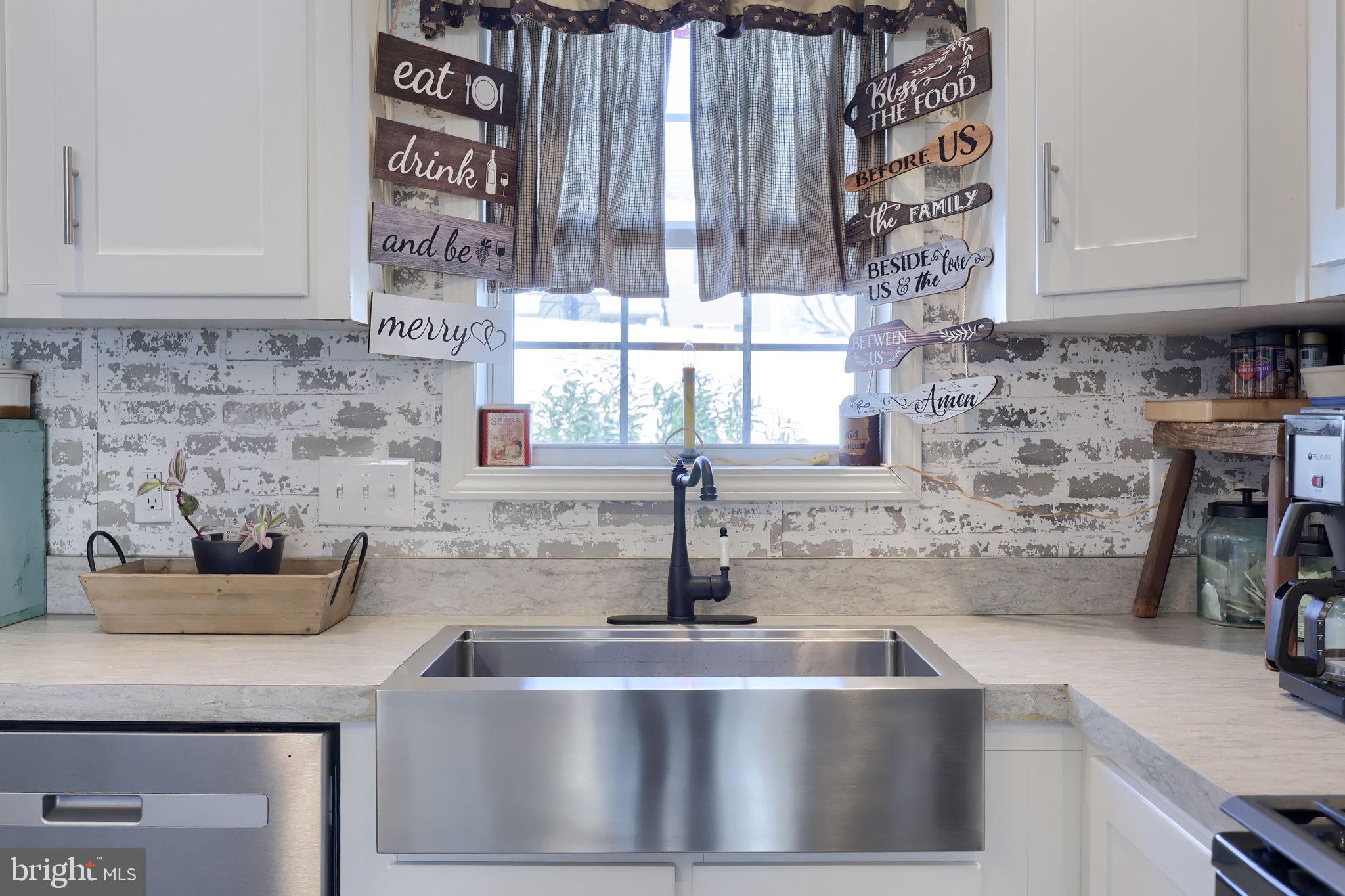 1395 Bowmansville Road Mohnton, PA 19540 - Photo 17 of 26 a kitchen with a sink and a refrigerator