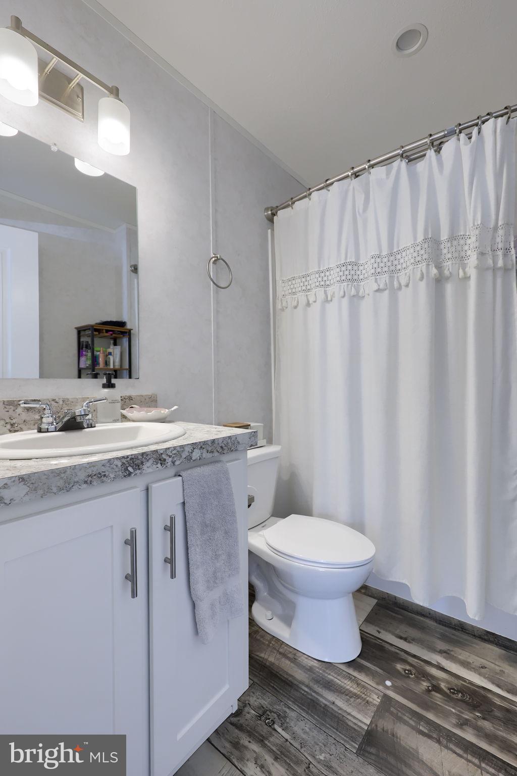 1395 Bowmansville Road Mohnton, PA 19540 - Photo 25 of 26 a bathroom with a granite countertop sink toilet and a mirror
