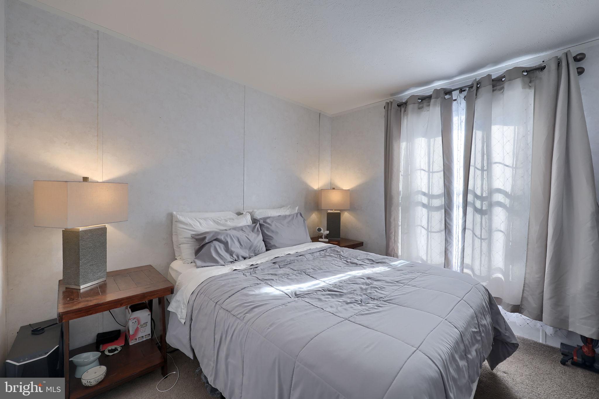 1395 Bowmansville Road Mohnton, PA 19540 - Photo 26 of 26 a bedroom with a bed a lamp and a large window