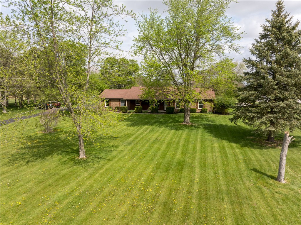 7988 McCool Road Greenville, OH 45331 - Photo 50 of 50 Sprawling lawn with mature trees frames this inviting single-story home.