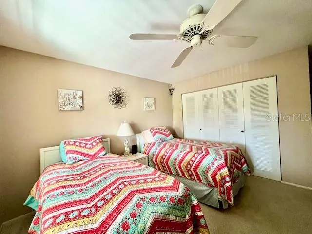 a bedroom with two beds and a chandelier