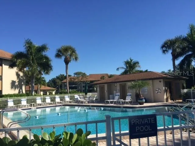 a view of swimming pool with outdoor seating and plants
