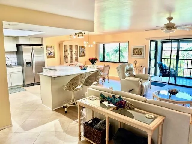 a living room with a large window and furniture