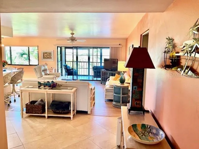 a living room with furniture a window and a table