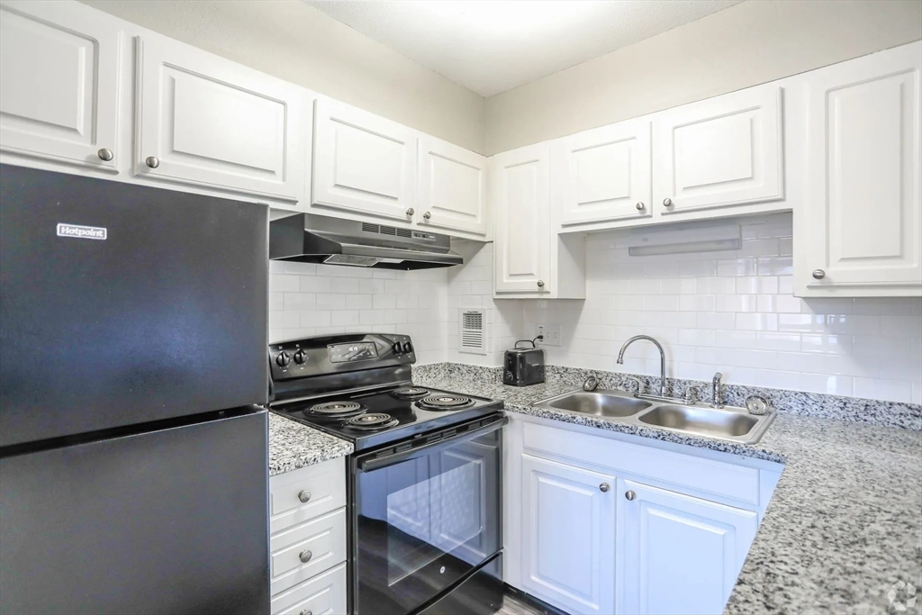 8 Lakeview Gardens, Unit 6 Natick, MA 01760 - Photo 6 of 13 a kitchen with stainless steel appliances a sink a stove and cabinets