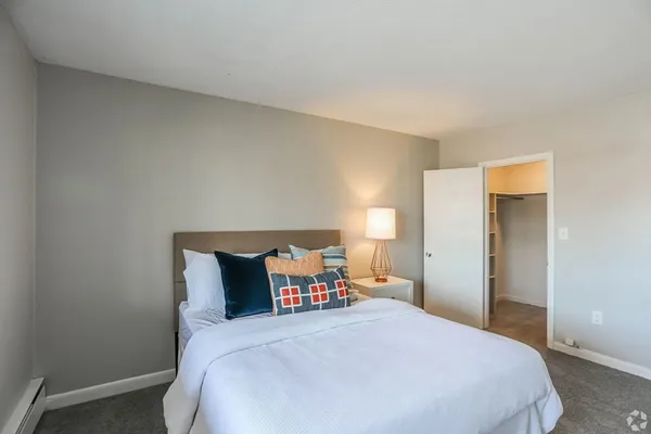 a bedroom with a bed and window