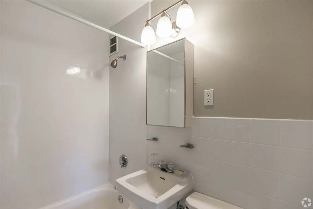 8 Lakeview Gardens, Unit 6 Natick, MA 01760 - Photo 9 of 13 a bathroom with a sink a toilet and shower