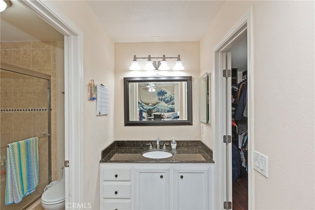 1834 West Las Palmas Circle Orange, CA 92868 - Photo 15 of 25 a bathroom with a granite countertop sink a mirror and a shower