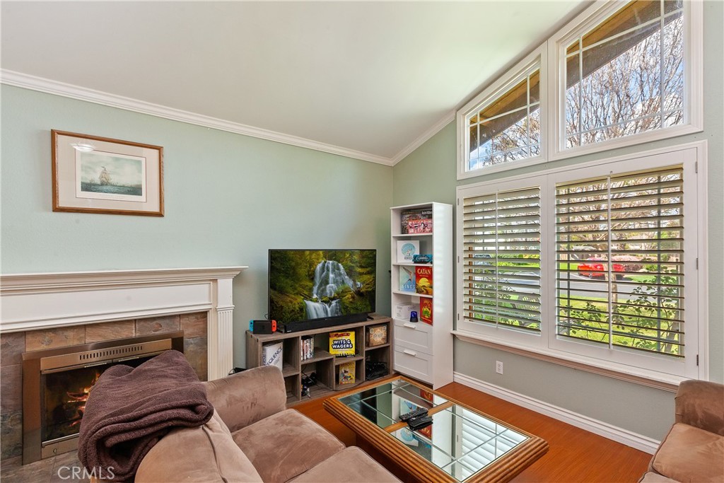 1834 West Las Palmas Circle Orange, CA 92868 - Photo 6 of 25 a living room with furniture a fireplace and a flat screen tv