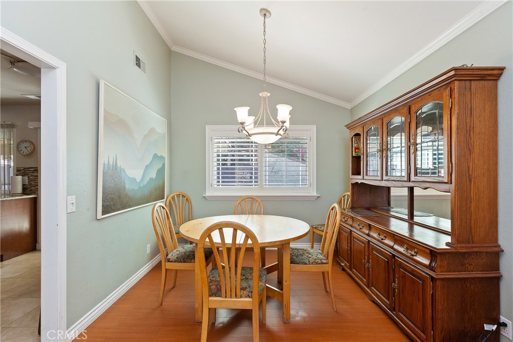1834 West Las Palmas Circle Orange, CA 92868 - Photo 8 of 25 a dining room with furniture a chandelier and wooden floor