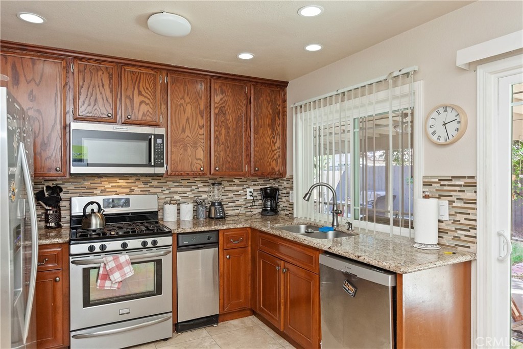 1834 West Las Palmas Circle Orange, CA 92868 - Photo 10 of 25 a kitchen with stainless steel appliances granite countertop a stove a sink and a microwave