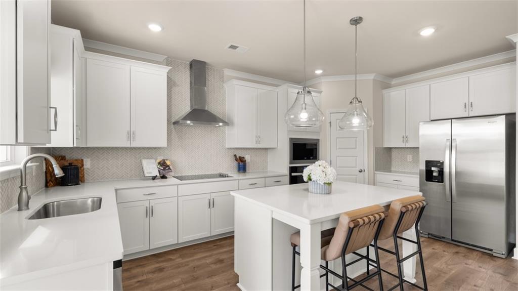 1787 Goodwin Drive Hampton, GA 30228 - Photo 17 of 55 a kitchen with stainless steel appliances a sink a stove a refrigerator and island