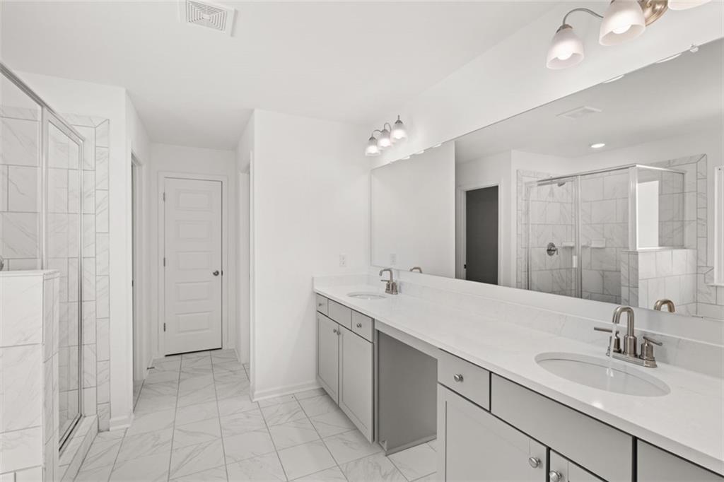 1787 Goodwin Drive Hampton, GA 30228 - Photo 34 of 55 a spacious bathroom with a double vanity sink mirror and