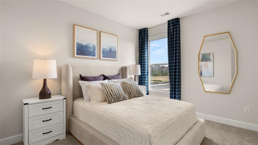 1787 Goodwin Drive Hampton, GA 30228 - Photo 35 of 55 a bedroom with a large bed and a lamp on dresser