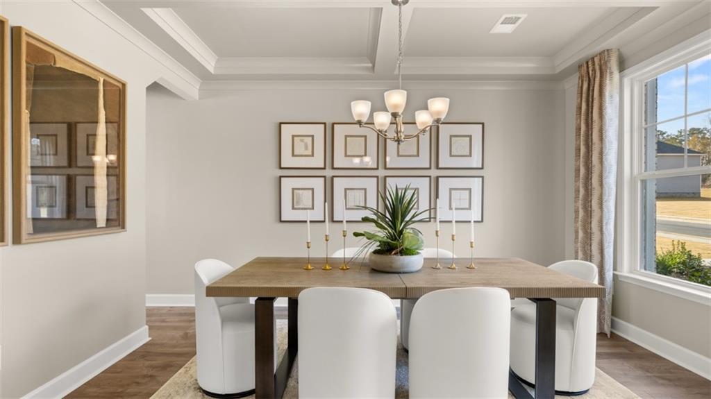 1787 Goodwin Drive Hampton, GA 30228 - Photo 6 of 55 a dining room with chandelier and wooden floor