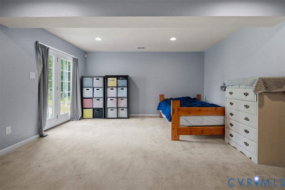 9013 Bailey Hill Road Midlothian, VA 23112 - Photo 51 of 56 Light-filled room featuring neutral carpet floorin