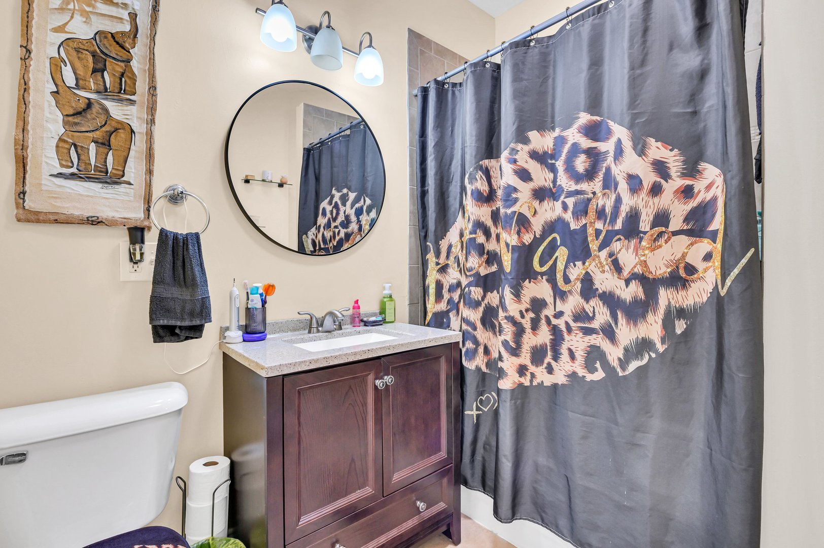 7208 South Eberhart Avenue Chicago, IL 60619 - Photo 15 of 20 a bathroom with a sink a toilet and a mirror