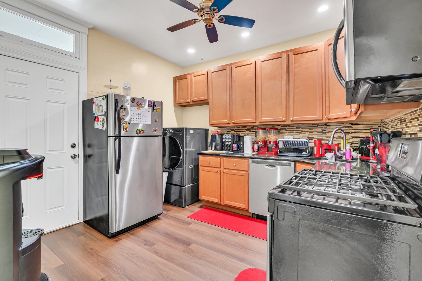 7208 South Eberhart Avenue Chicago, IL 60619 - Photo 17 of 20 a kitchen with stainless steel appliances granite countertop a refrigerator sink stove and cabinets
