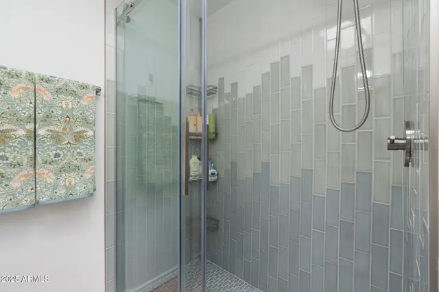 a bathroom with a glass shower door