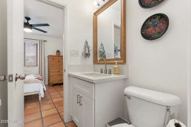 a bathroom with a toilet a sink and a mirror