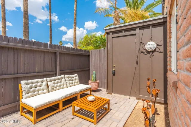 a wooden bench sitting in front of a building