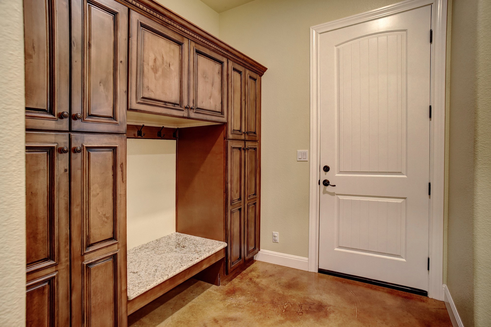 115 Pine Point Cove Elgin, TX 78621 - Photo 28 of 39 A well-appointed mudroom offers custom cabinetry and practical bench seating, perfect for daily transitions.