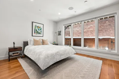 a bedroom with a large bed and a large window