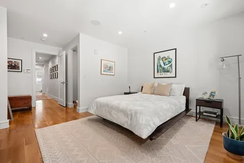 a spacious bedroom with a bed and a couch