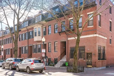 a car parked in front of a brick building