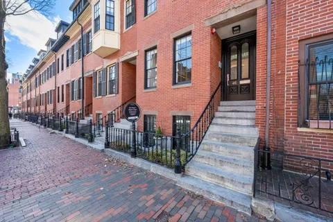 a view of a brick house with wooden floor and a stairs