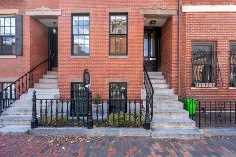 a view of a brick house with many windows