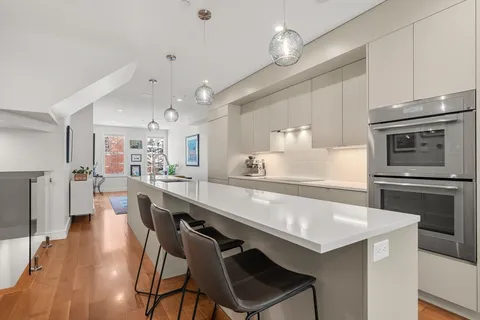 a large kitchen with a table and chairs in it