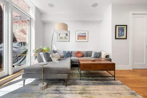 a living room with furniture and next to a window