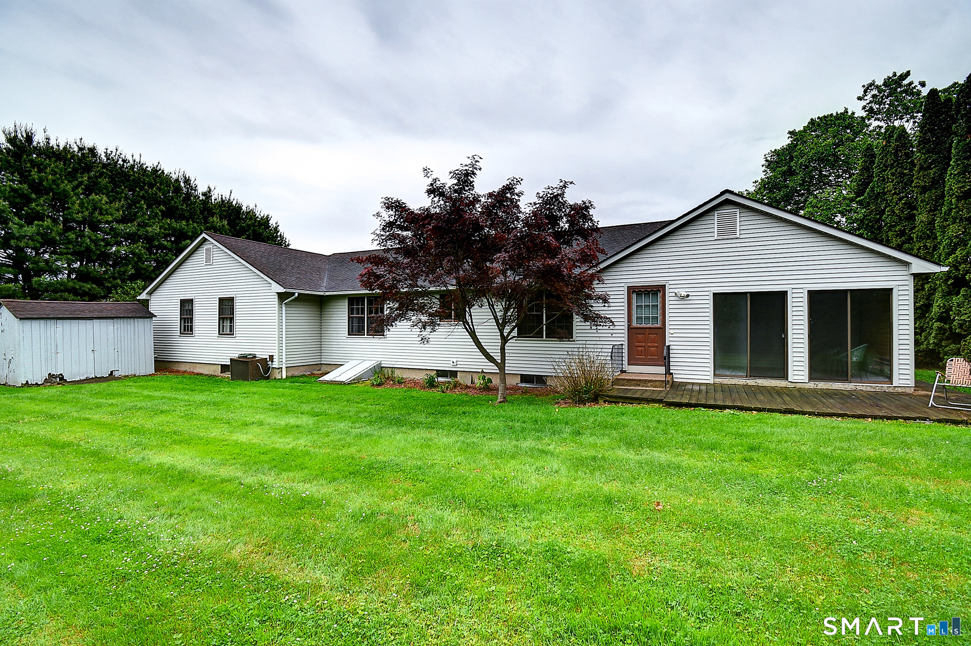 80 Grist Mill Road Wethersfield, CT 06109 - Photo 39 of 40 a front view of a house with a garden and yard