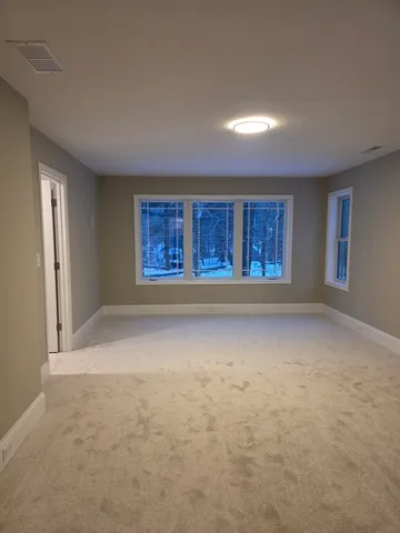 an empty room with a empty space and windows