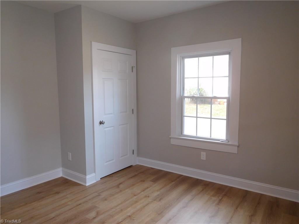 3830 Robinhood Road Winston-Salem, NC 27106 - Photo 15 of 30 BEDROOM 1 IS THE LARGEST BEDROOM. THERE IS NOT A TRUE PRIMARY IN THIS HOME AS THERE IS NO PRIMARY SUITE.