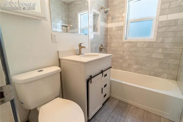 a bathroom with a sink a toilet and bathtub