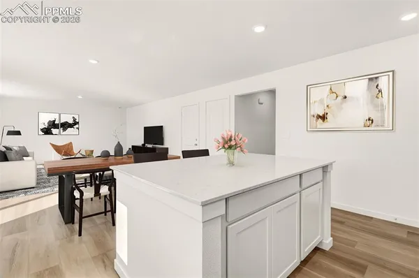 a view of kitchen island with furniture and wooden floor