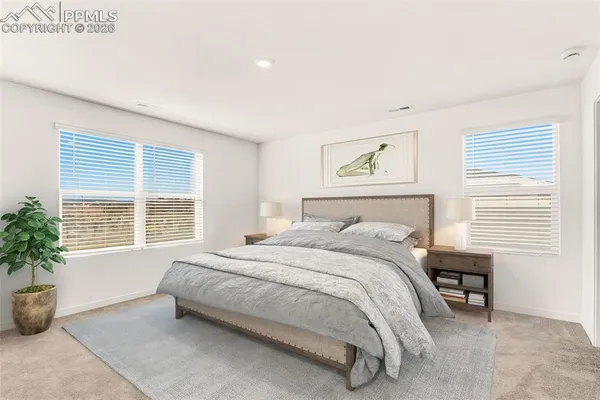 a bedroom with a bed and a potted plant