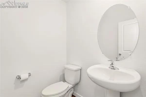 a bathroom with a sink mirror and toilet