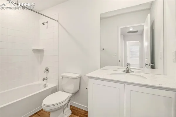 a bathroom with a sink toilet vanity and shower