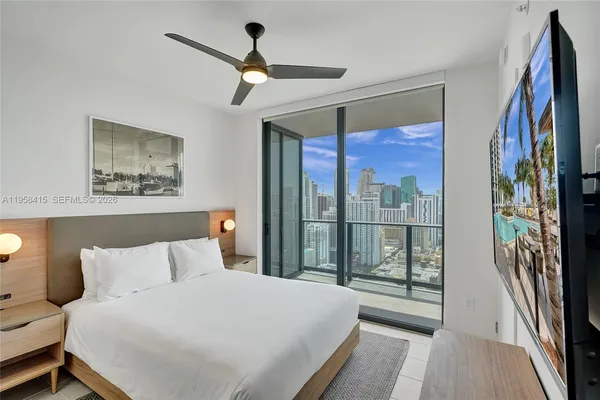 a bedroom with a large bed and a large window