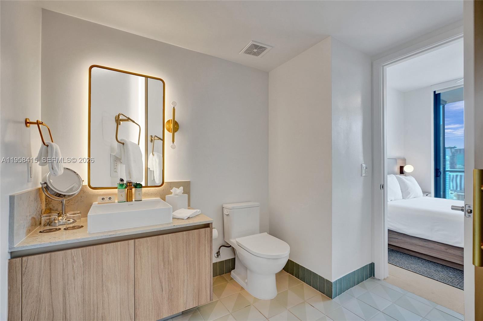 159 Northeast 6th Street, Unit 3405 Miami, FL 33132 - Photo 16 of 37 a bathroom with a sink and a mirror